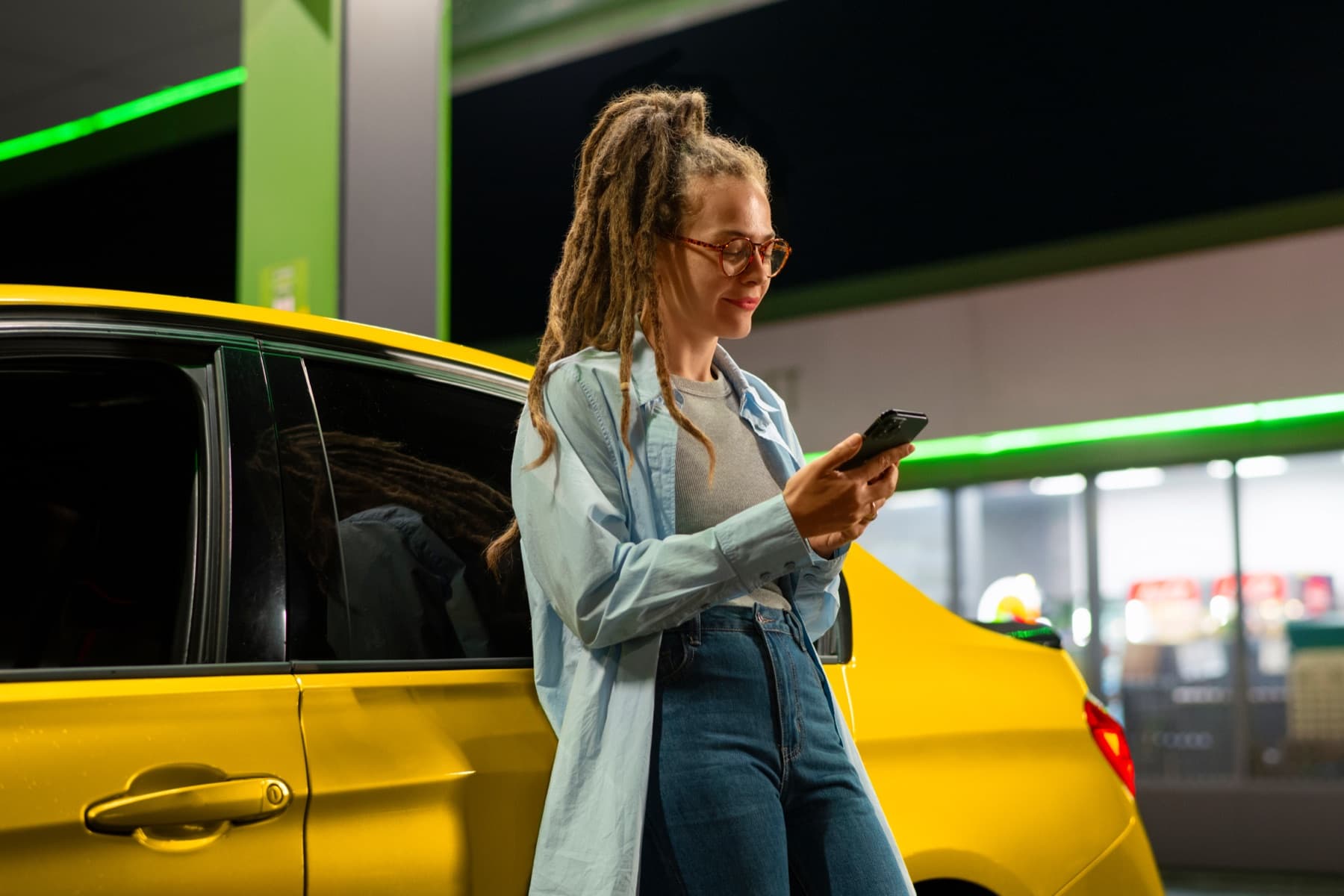 A woman standing near a taxi